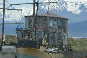 An old boat along the spit that someone lives in.