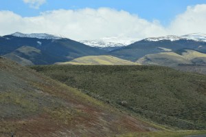 Teton mountains peeki ng out above the hills.