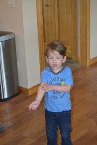 Their son Tyson just up from a nap explaining something important about his arm.